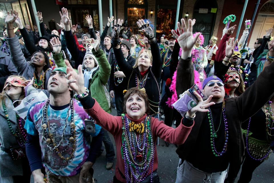 Revelers beg for beads to be tossed from a balcony in the French Quarter during Mardi Gras day  in New Orleans, Louisiana. The annual Mardi Gras celebration on Feb. 13 ends at midnight, when the Catholic Lenten season begins on Ash Wednesday and ends on Easter Sunday.