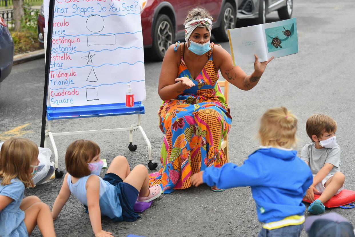 A teacher conducts a lesson with students during an outdoor learning demonstration for New York City schools in front of the Patrick F. Daly public school (P.S. 15) on September 2, 2020 in the Brooklyn borough of New York City. (Photo by Angela Weiss / AFP) (Photo by ANGELA WEISS/AFP via Getty Images)