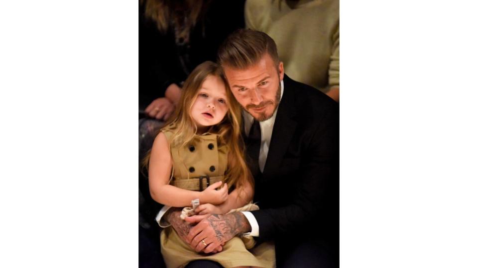  Harper Beckham and dad David at the Burberry show in 2015