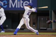 Texas Rangers' Josh Smith follows through on a single to right in the second inning of a baseball game against the Tampa Bay Rays, Monday, May 30, 2022, in Arlington, Texas. The hit was Smith's first in his major league appearance. (AP Photo/Tony Gutierrez)