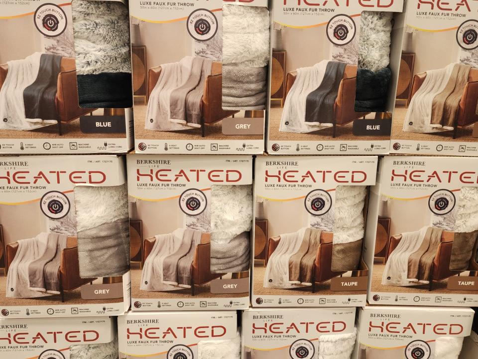 Stacked boxes of heated throw blankets.