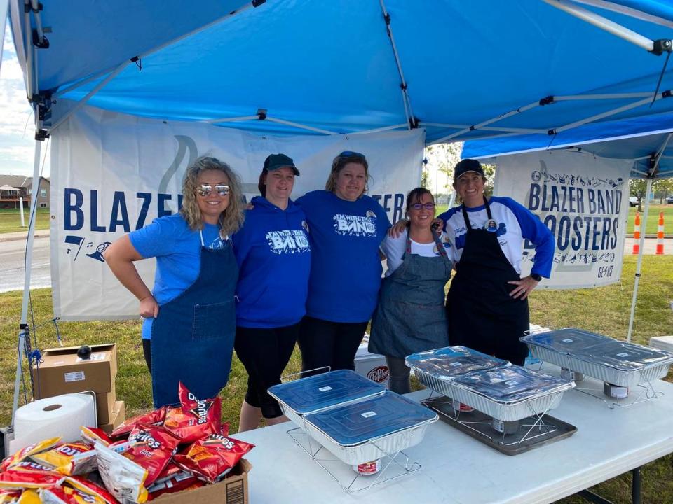 From left, Sheila Sloss, Nichole Griffith, Stephanie Bryan, Kari Tomlinson and Amy Higgins work a homecoming football game fundraiser for the Blazer Band Booster club.