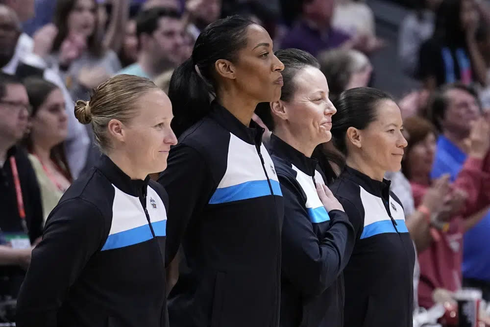 An all-women officiating crew stands at mid court during the national anthem before an NCAA Women’s Final Four semifinals basketball game between LSU and Virginia Tech Friday, March 31, 2023, in Dallas. (AP Photo/Tony Gutierrez)