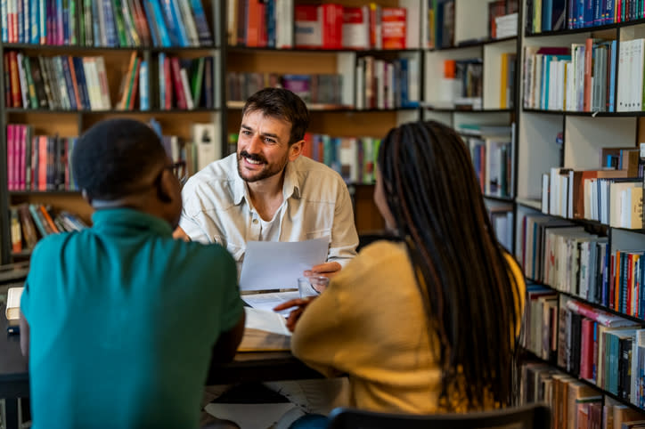 A couple reviewing educational tax credits with a financial advisor.