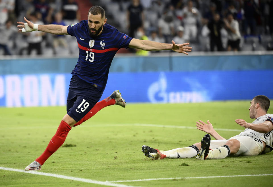 France's Karim Benzema runs to celebrate scoring a goal that was overturned for an offside during the Euro 2020 soccer championship group F match between Germany and France at the Allianz Arena stadium in Munich, Tuesday, June 15, 2021. (Franck Fife/Pool via AP)