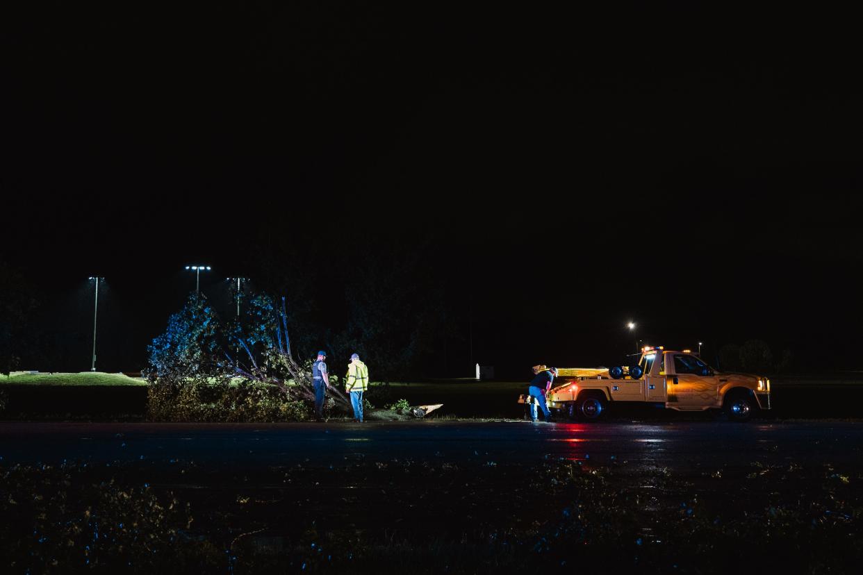 Emergency crews employed wreckers to remove downed trees blocking Adam's Blvd moments after a tornado hit Bartlesville.