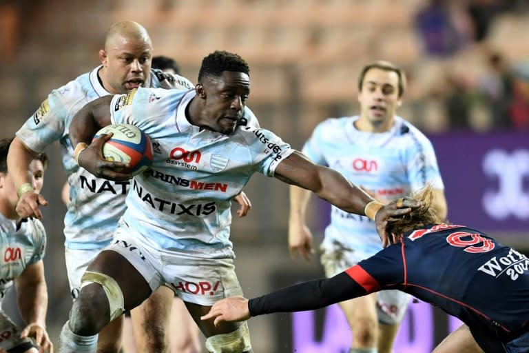 Racing Metro 92 flanker Yannick Nyanga (C-L) attempts to evade tackle by Grenoble's scrum-half Charl Mcleod during their French Top 14 rugby union match, at the Stade des Alpes in Grenoble, on March 4, 2017