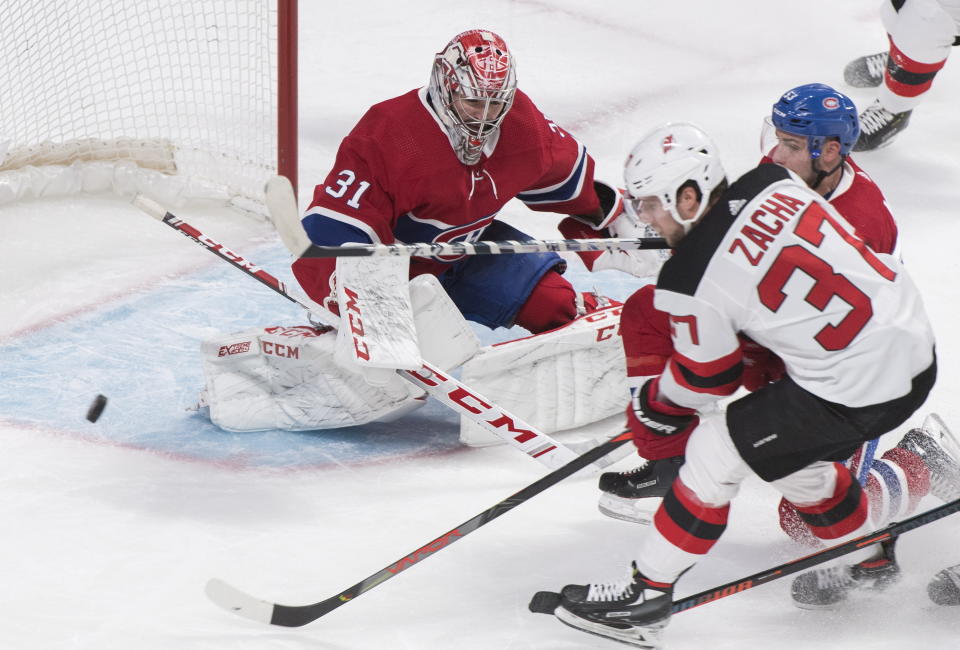New Jersey Devils' Pavel Zacha (37) moves in on Montreal Canadiens goaltender Carey Price as Canadiens' Victor Mete (53) defends during second-period NHL hockey game action in Montreal, Thursday, Nov. 28, 2019. (Graham Hughes/The Canadian Press via AP)