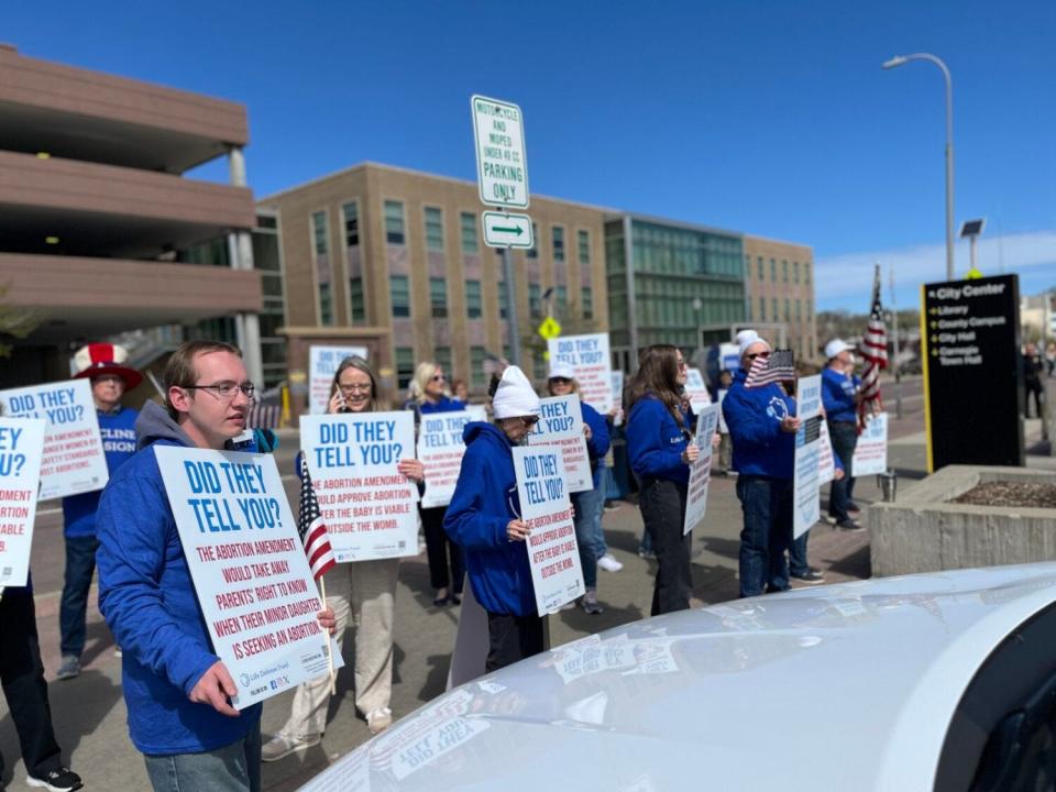 Anti-abortion protesters with the Life Defense Fund outside of the downtown Sioux Falls library on May 1, 2024.