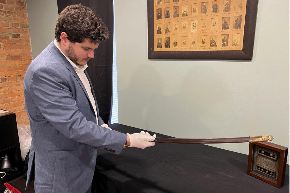 Adam Fleischer, President of Fleischer's Auctions, holds Civil War Union Gen. William Tecumseh Sherman's sword and scabbard, Thursday, May 9, 2024, in Columbus, Ohio. The wartime sword, likely used between 1861 and 1863, are among the items that will be open to bidders Tuesday, May 14, 2024, at Fleischer’s Auctions. (AP Photo/Patrick Orsagos)
