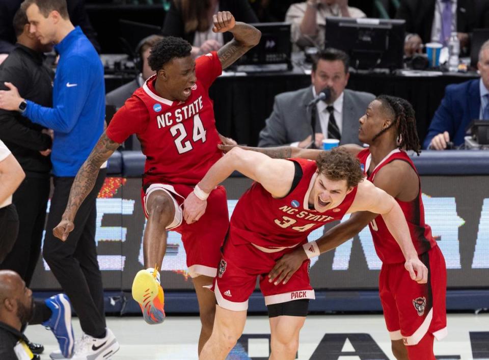 N.C. State’s Ernest Ross (24), Ben Middlebrooks (34) and D.J. Horne (0) celebrate their 76-64 victory over Duke in the NCAA South Regional final, securing a spot in the Final 4, on Sunday, March 31, 2024 at the American Airlines Center in Dallas, Texas.