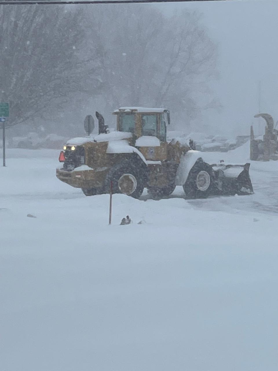 Plows and loaders clearing snow-packed roads near the state Department of Motor Vehicles office in Norwich in January 2022.