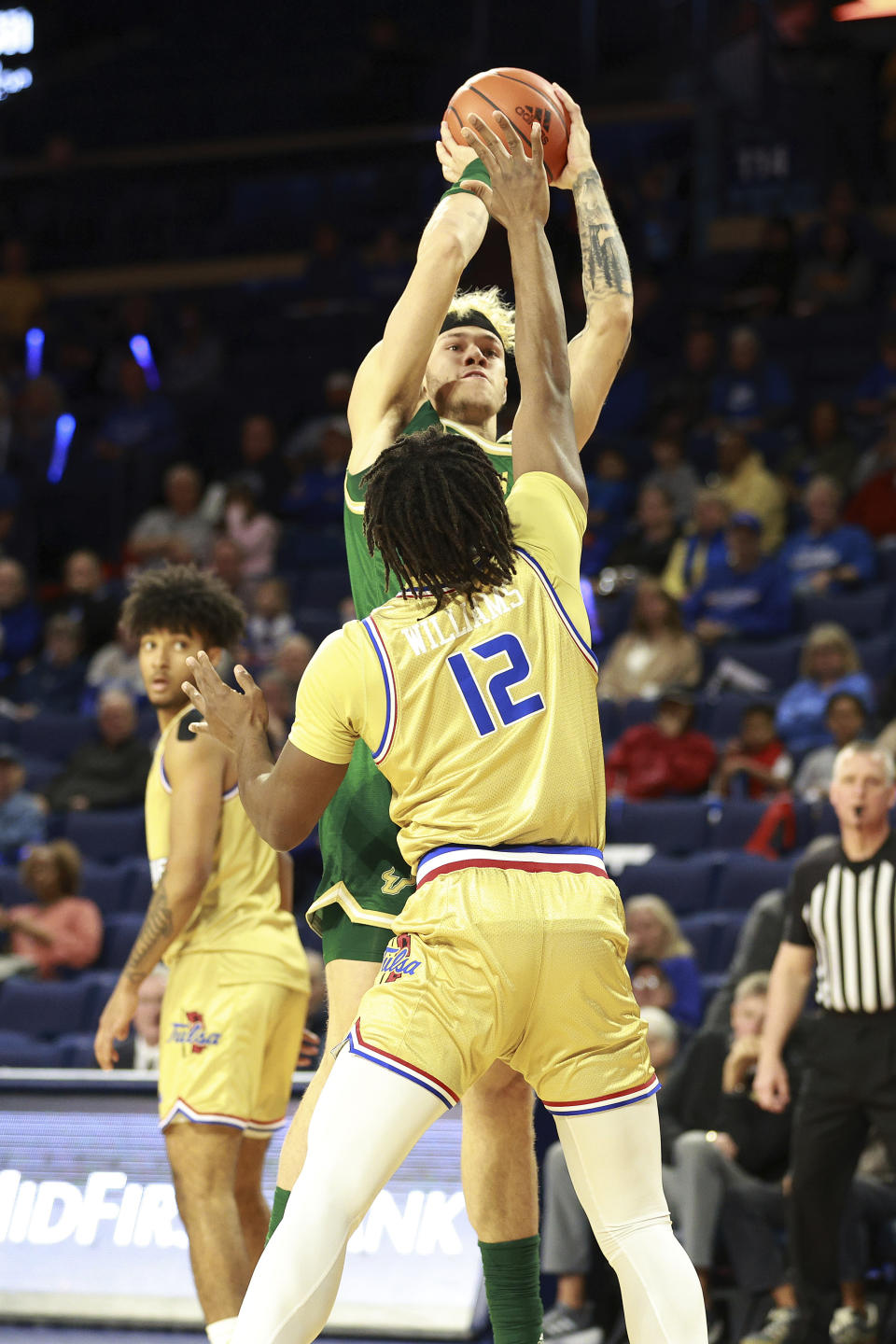 South Florida forward Kasean Pryor (11) shoots over Tulsa forward Carlous Williams (12) during the first half of an NCAA college basketball game, Saturday, March 9, 2024, in Tulsa, Okla. (AP Photo/Joey Johnson)