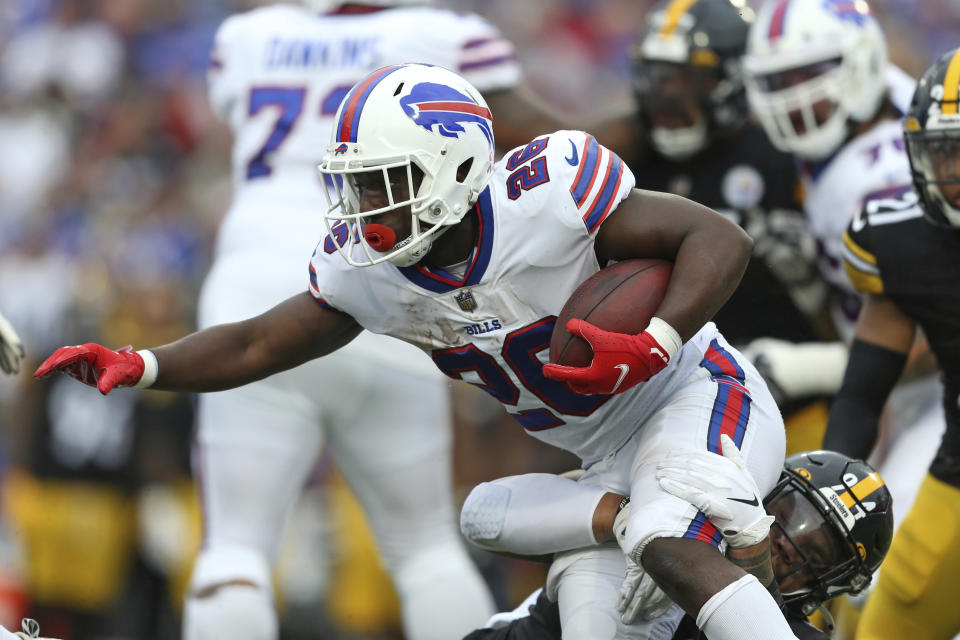 Buffalo Bills running back Devin Singletary (26) is tackled by Pittsburgh Steelers defensive end Tyson Alualu (94) during the first half of an NFL football game in Orchard Park, N.Y., Sunday, Sept. 12, 2021. (AP Photo/Joshua Bessex)