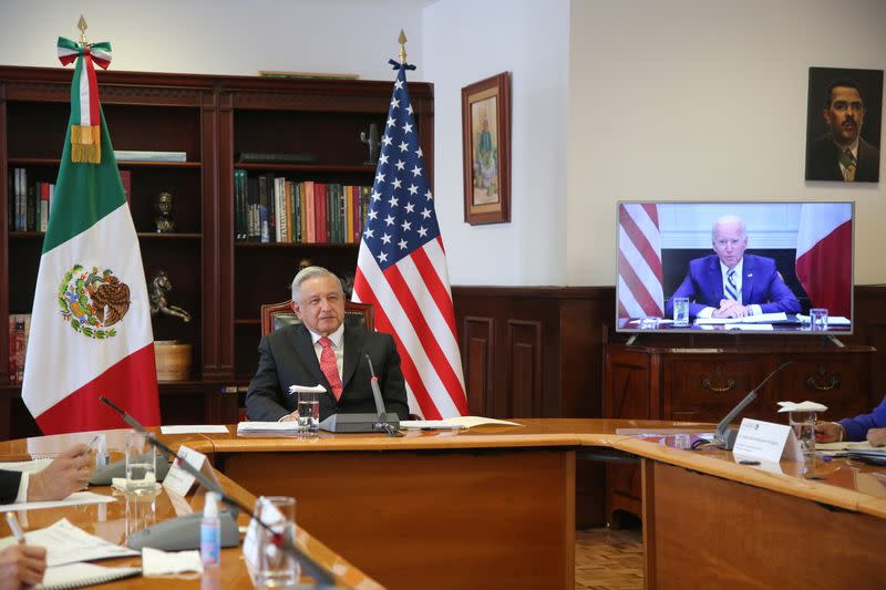 Mexico's President Manuel Lopez Obrador listens from the National Palace in Mexico City during a virtual bilateral meeting with U.S. President Biden