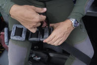 University of Miami's Rosenstiel School of Marine & Atmospheric Science professor Andrew Baker puts weights on a dive belt as he prepares for a night dive to check on coral spawning, Monday, Aug. 15, 2022, in Key Biscayne, Fla. A group of students and scientists were hoping to observe the coral spawn and collect their eggs and sperm, called gametes, to take back to the lab to hopefully fertilize and create new coral that will later be transplanted to help repopulate part of the Florida Reef Tract. (AP Photo/Wilfredo Lee)