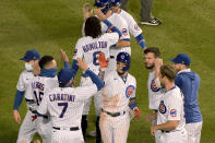 Chicago Cubs' Javier Baez (9) celebrates with teammates after driving in the winning run during the 10th inning against the Cleveland Indians in a baseball game Wednesday, Sept. 16, 2020, in Chicago. (AP Photo/Mark Black)