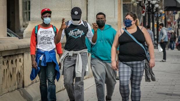 A group of people walking in masks in downtown Ottawa on March 23, 2021. Mask use might be around for a while, according to experts.