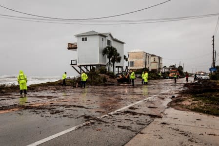 Florida Department of Transportation members work on the A1A closed coastal route of Vilano Beach due to debris and flooding from Hurricane Dorian, in St. Augustine