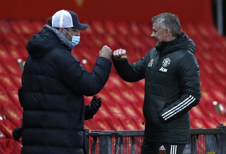 Liverpool manager Jurgen Klopp, fistbumps Manchester United manager Ole Gunnar Solskjaer, right (Phil Noble/PA) (PA Archive)