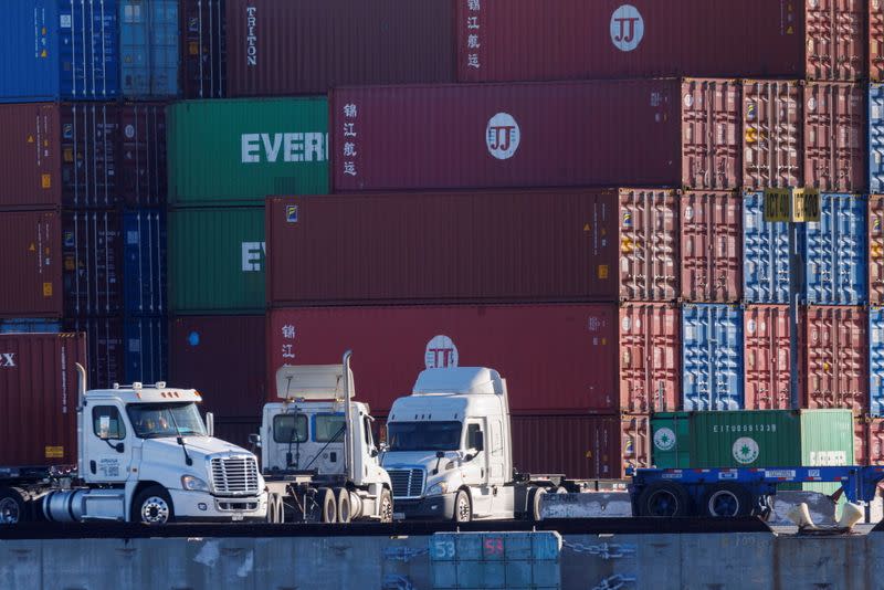 FILE PHOTO: Trucks arrive to pick up containers at the Port of Los Angeles in Los Angeles, California