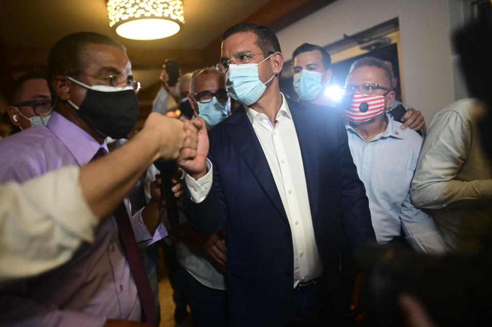 Pedro Pierluisi, gubernatorial candidate with the New Progressive Party (PNP), arrives at Vivo Beach Club to celebrate a slim lead of the pro-statehood party in the Puerto Rican general elections, in Carolina, Puerto Rico, Tuesday, Nov. 3, 2020. Pierluisi briefly served as governor following last year's massive protests that led to the resignation of former Gov. Ricardo Rosselló. (AP Photo/Carlos Giusti)