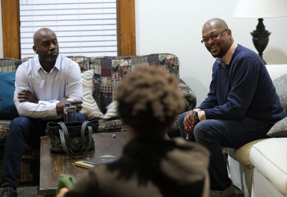 Alpha Phi Alpha fraternity alumni Daryl Davis, left, and Timber Smith talk about mentoring with residents at A Better Chance house in Appleton.