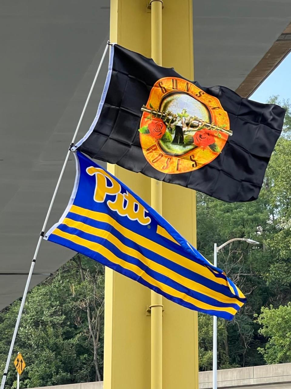 A Guns N' Roses flag waves in a parking lot outside PNC Park in downtown Pittsburgh on Friday before the Rock & Roll Hall of Fame band's concert.