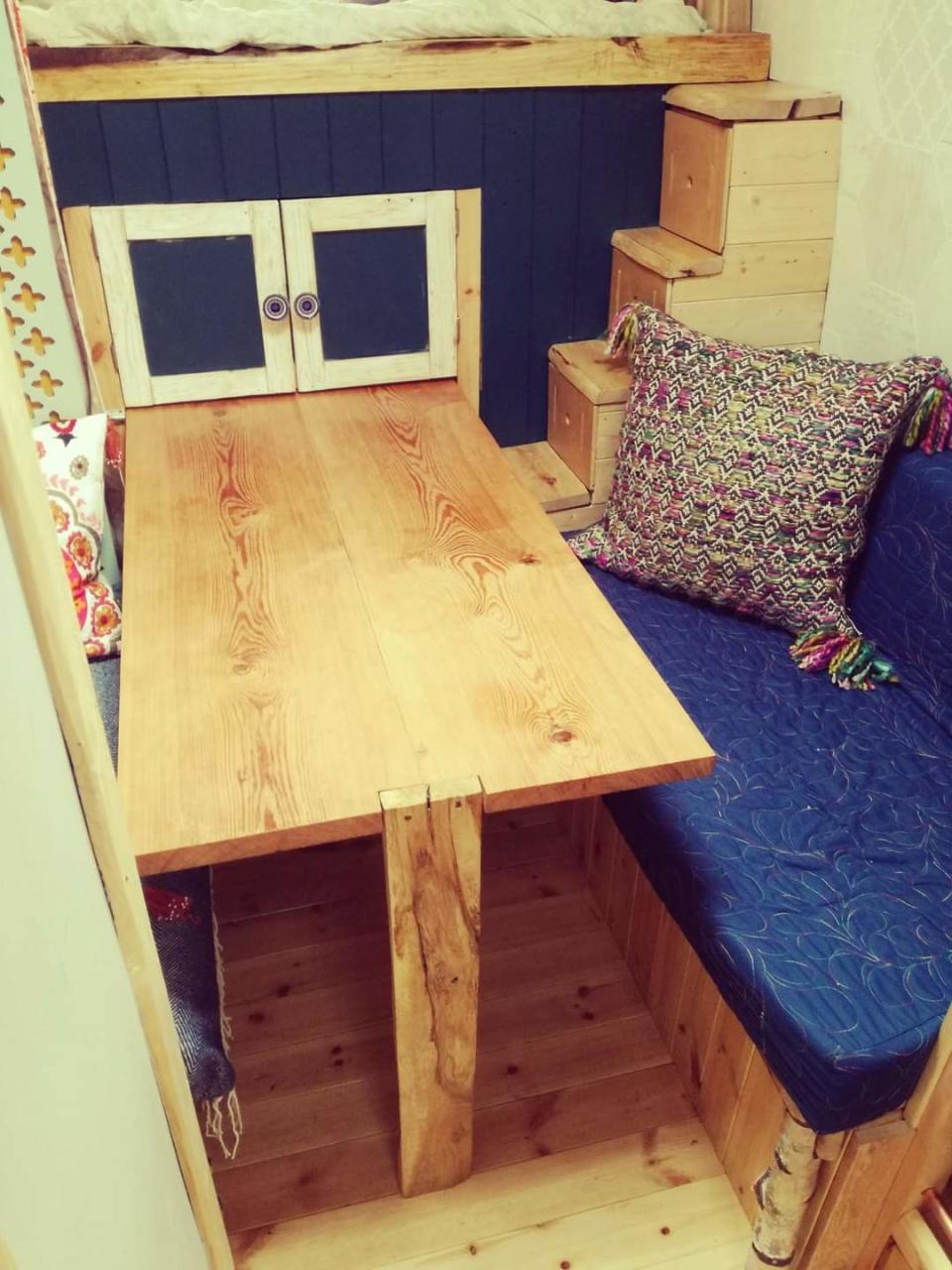 A pull-out dining table and seating area in the Firetruck Family's converted van.