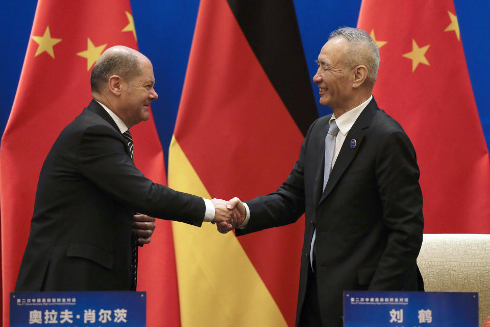 German Finance Minister Olaf Scholz, left, shakes hands with Chinese Vice Premier Liu He after they witnessed a signing ceremony for the China-Germany High Level Financial Dialogue at the Diaoyutai State Guesthouse in Beijing, Friday, Jan. 18, 2019. (AP Photo/Andy Wong, Pool)