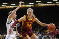 Iowa State guard Ashley Joens (24) drives to the basket past Iowa guard Kate Martin (20) during the first half of an NCAA college basketball game, Wednesday, Dec. 7, 2022, in Iowa City, Iowa. (AP Photo/Charlie Neibergall)