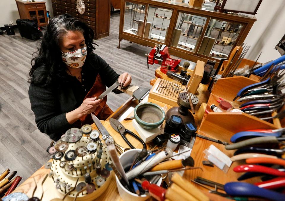 Argentum et Aurum Jewelry store owner Monica Lara works on a ring at her store's worktable on Jan. 21, 2021. The downtown Fond du Lac store recently moved into a bigger space at 111 S. Main St.