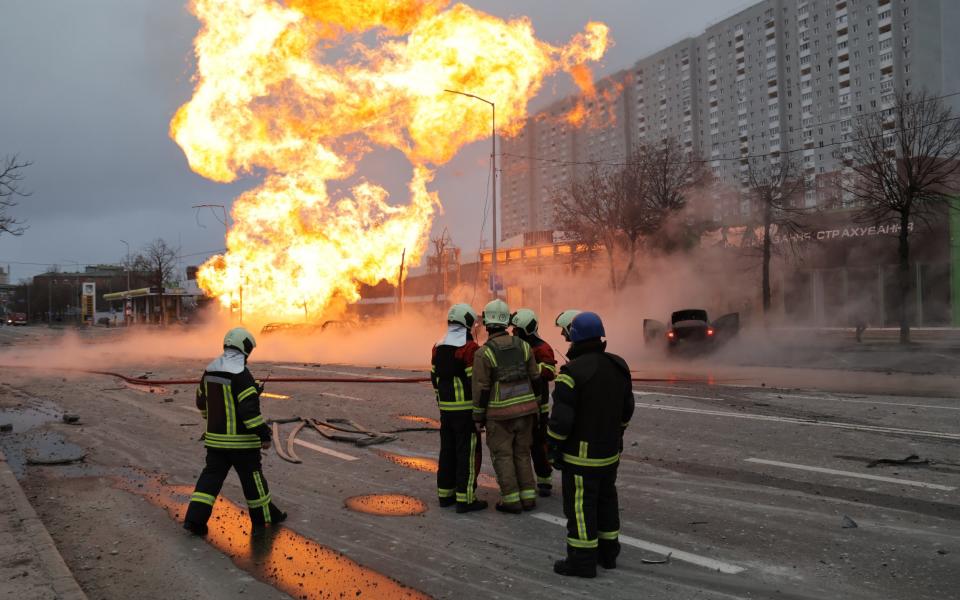 Firefighters tackle a blaze caused by falling rocket debris