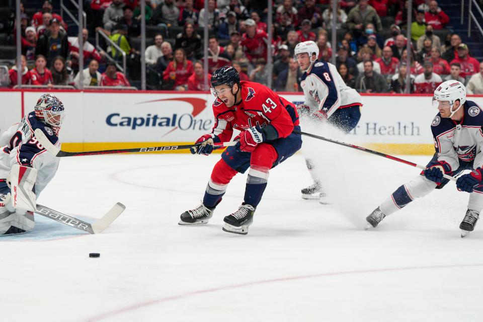 Washington Capitals right wing Tom Wilson (43) skates toward the goal while defended by Columbus Blue Jackets' Damon Severson (78), who was called for a penalty during the first period of an NHL hockey game Saturday, Nov. 4, 2023, in Washington. (AP Photo/Jess Rapfogel)