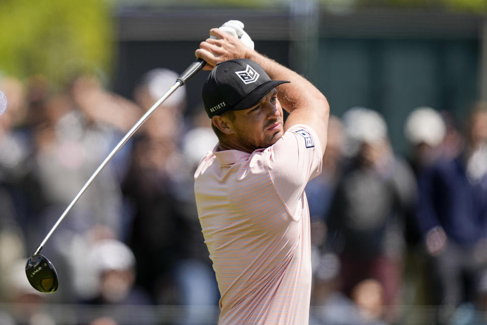 Bryson DeChambeau watches his tee shot on the 14th hole during the first round of the PGA Championship golf tournament at Oak Hill Country Club on Thursday, May 18, 2023, in Pittsford, N.Y. (AP Photo/Eric Gay)