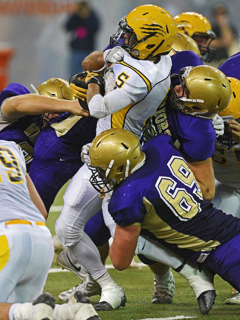 Groton Area's Trevon Tuggles (5) is brought down by a group of Winner defenders, including Krockett Krolikowski (69) and Levi McClanahan (55), during the 2016 South Dakota State Class 11B Football Championship game Friday, Nov. 11, 2016, at the DakotaDome on the University of South Dakota campus in Vermillion, S.D. Winner beat Groton Area 54-0. 