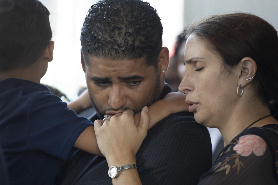 Juan Rodriguez, holding his son Tristan, leaves Bronx Criminal Court with his wife Marissa after a hearing, Thursday, Aug. 1, 2019 in New York. The New York father has pleaded not guilty to manslaughter and other charges in the deaths of their 1-year-old twins left in a car on Friday while he put in a day at work. Prosecutors say Rodriguez told police he thought he had dropped the twins off at day care. They say he told police "I blanked out. My babies are dead. I killed my babies." (AP Photo/Mark Lennihan)