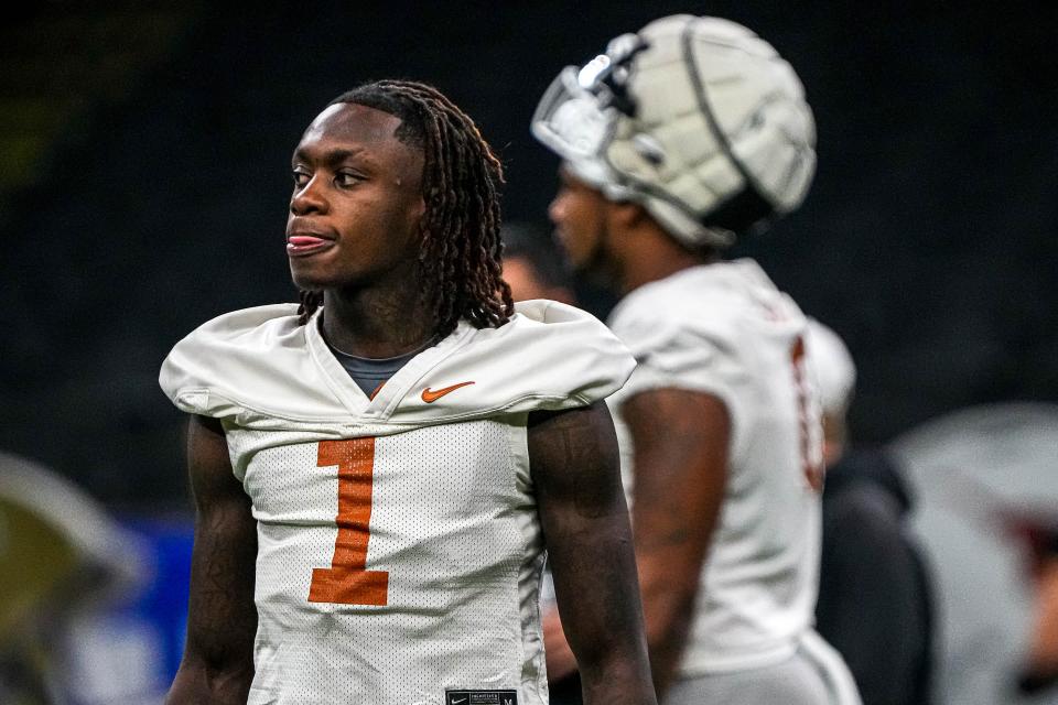 Texas wide receiver Xavier Worthy, left, announced on Tuesday that he will enter the NFL draft, becoming the first Longhorns underclassman to declare early. He's leaving as the fourth-leading receiver in Longhorns history.