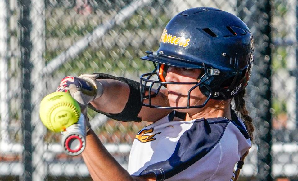 Mooresville's Zoey Kugelman (21) gets a hit during a game between the Center Grove High School Trojans and the Mooresville High School Pioneers on Monday, May 23, 2022, at Mooresville Schools in Ind. 