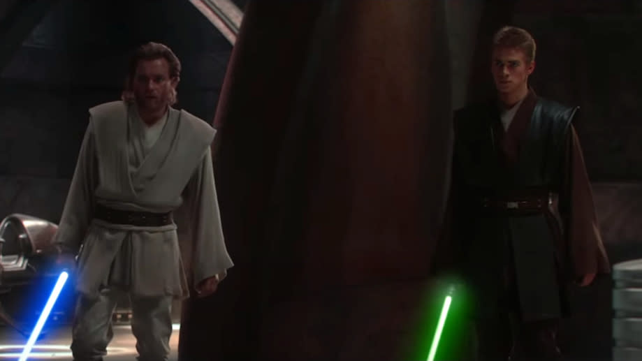 Characters Obi-Wan Kenobi and Anakin Skywalker in Jedi attire with lit lightsabers from the Star Wars series