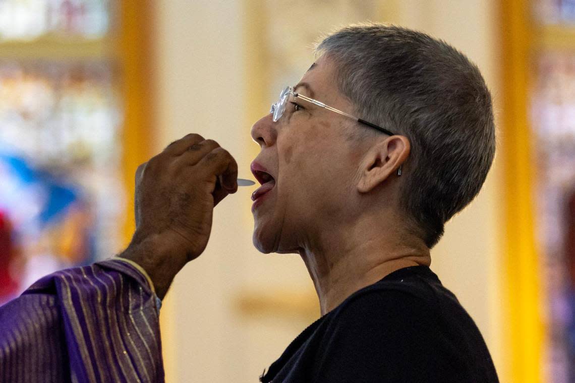 A congregant receives the Eucharist during an Ash Wednesday service at Gesù Church. D.A. Varela/dvarela@miamiherald.com