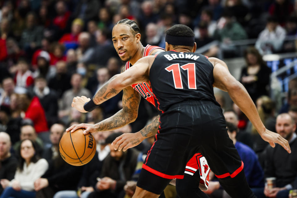 Chicago Bulls forward DeMar DeRozan is defended by Toronto Raptors forward Bruce Brown during the first half of an NBA basketball game Thursday, Jan. 18, 2024, in Toronto. (Christopher Katsarov/The Canadian Press via AP)