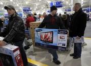 Matt Giardina carries his purchase, a HDTV, at a Best Buy store on the shopping day dubbed "Black Friday" in Framingham, Massachusetts November 25, 2011. REUTERS/Adam Hunger