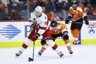 Carolina Hurricanes' Brady Skjei (76) tries to keep away from Philadelphia Flyers' Claude Giroux (28) during the second period of an NHL hockey game, Thursday, March 5, 2020, in Philadelphia. (AP Photo/Matt Slocum)