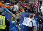 Race fans congratulate Meb Keflezighi, of San Diego, Calif., on his win in the 118th Boston Marathon Monday, April 21, 2014 in Boston. (AP Photo/Elise Amendola)