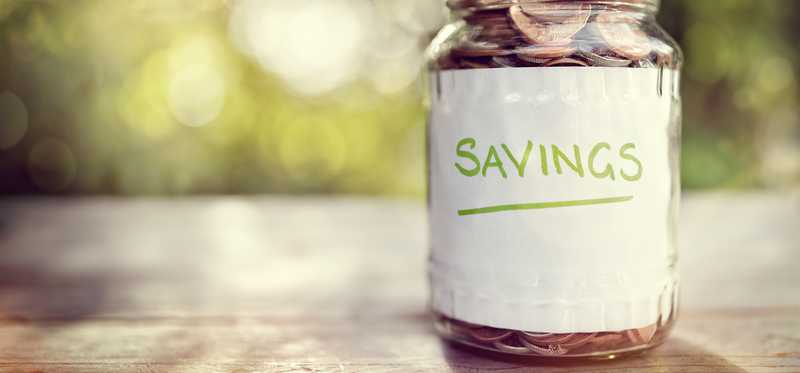 A jar labeled "savings" filled with coins