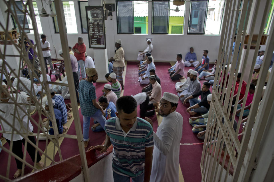 A Muslim volunteer assigned to spot unfamiliar visitors looks at a man ahead of Friday prayers in Colombo, Sri Lanka, Friday, April 26, 2019. Religious leaders cancelled large public gatherings amid warnings of more attacks, along with retaliatory sectarian violence in Sri Lanka though some still held communal Friday prayers at mosques. (AP Photo/Gemunu Amarasinghe)