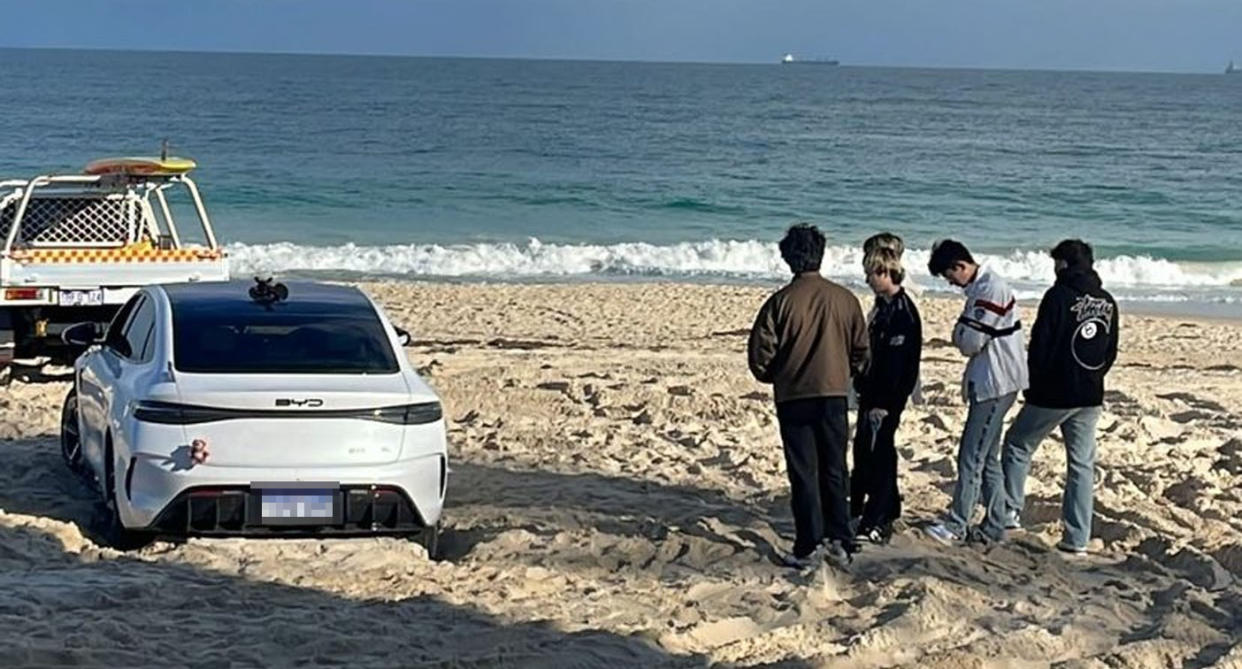 Five men stand next to the BYD on City beach.