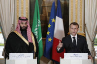 FILE - French President Emmanuel Macron, right, and Saudi Arabia Crown Prince Mohammed bin Salman attend a press conference at the Elysee Palace in Paris, Tuesday, April 10, 2018. Still reeling from the recent submarine deal rapture by Western allies, French President Emmanuel Macron is visiting the energy-rich Arab countries of the Persian Gulf on Friday Dec. 3, 2021, with an aim to close a lucrative arms deal and strengthen France's leadership role in renewed international efforts to revive Iran's cratered nuclear deal with world powers. (Yoan Valat/Pool via AP, File)