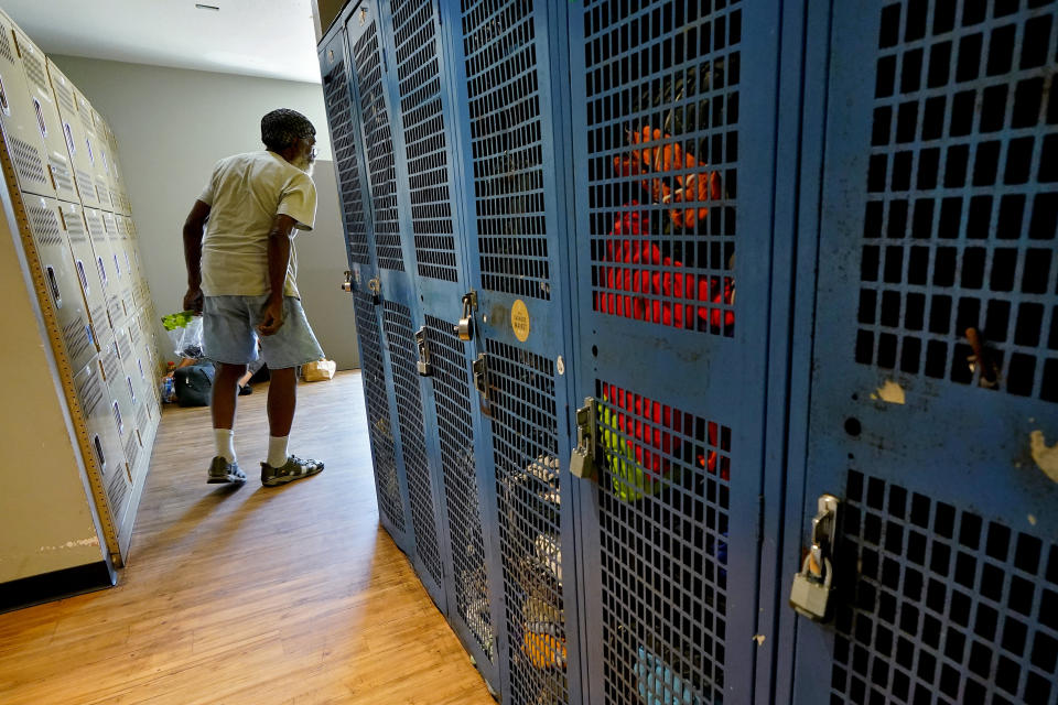 A homeless man cools off after showering at the Justa Center, a day cooling center for homeless people 55 years and older, Friday, July 14, 2023, in downtown Phoenix. During the cooler months, the center stays open until 2 p.m. but has been staying open to at least 5:30 p.m. most days during the current heat spell. (AP Photo/Matt York)